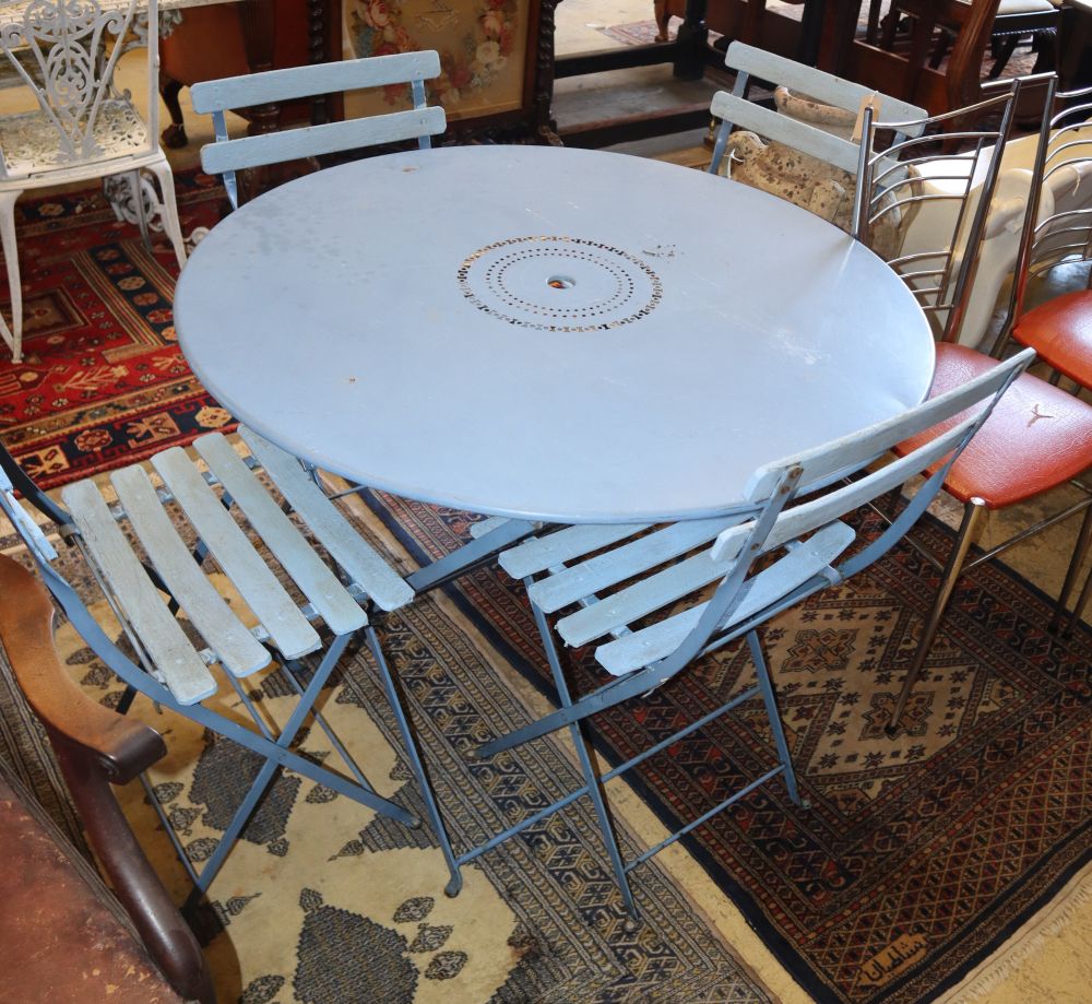A blue painted circular folding garden table, 100cm diameter, H.72cm together with four folding garden chairs